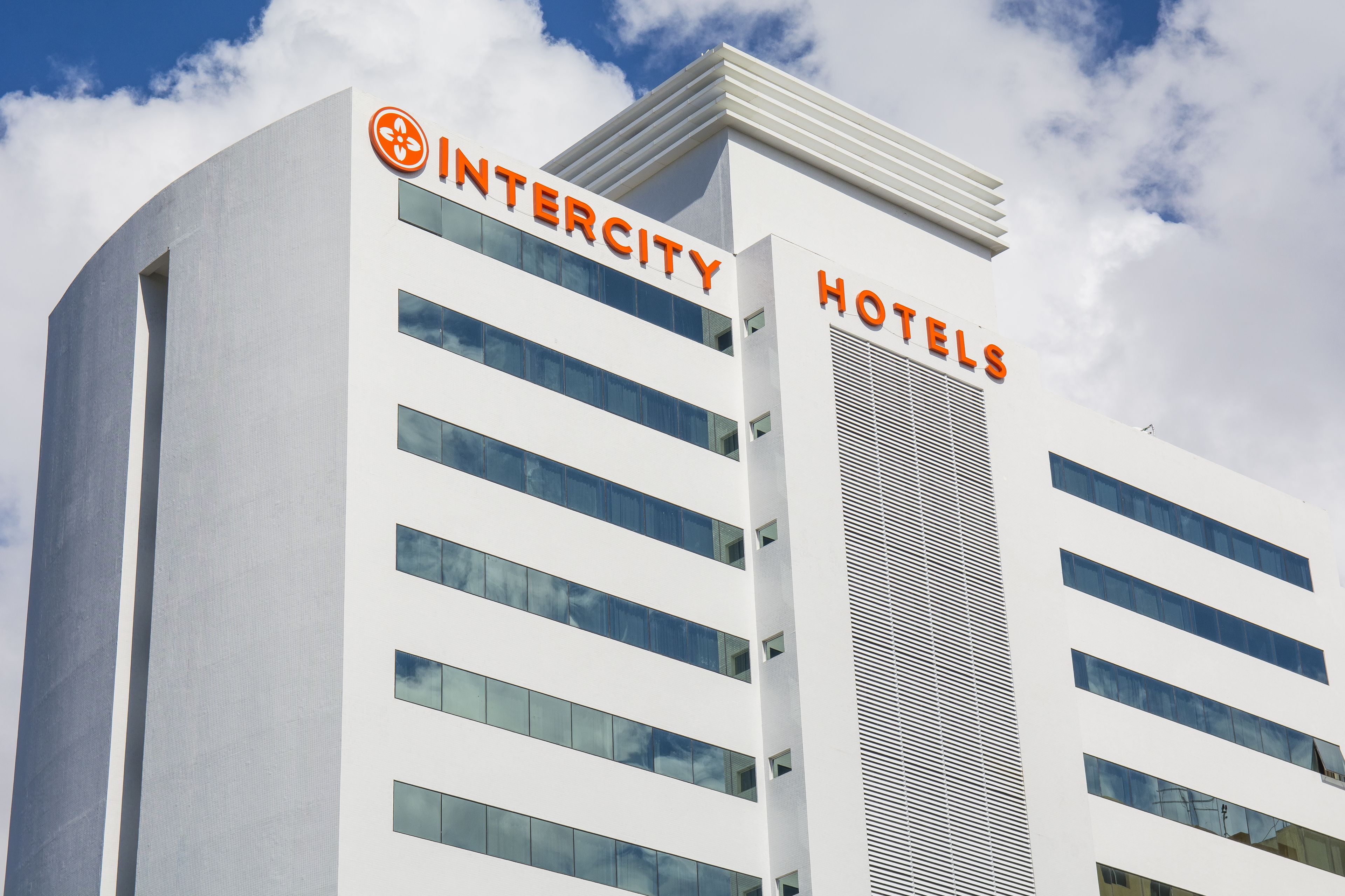 A modern Intercity Hotels building with a prominent sign, multiple floors, and large windows.