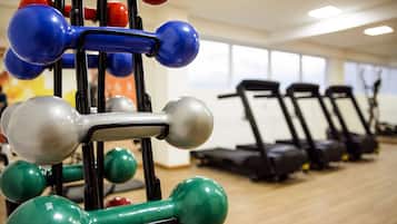 A gym with exercise equipment and treadmills.