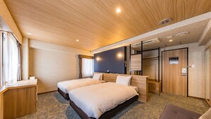 A hotel room with two beds, a desk, a wardrobe, and a seating area. - Fukuoka Toei Hotel (Fukuoka)
