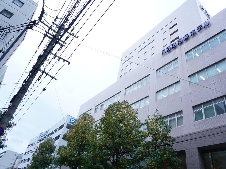 A multi-story building with a modern architectural design, featuring a prominent signage on the facade.