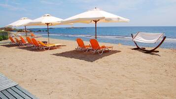 On the beach, sun loungers, beach umbrellas, kayaking