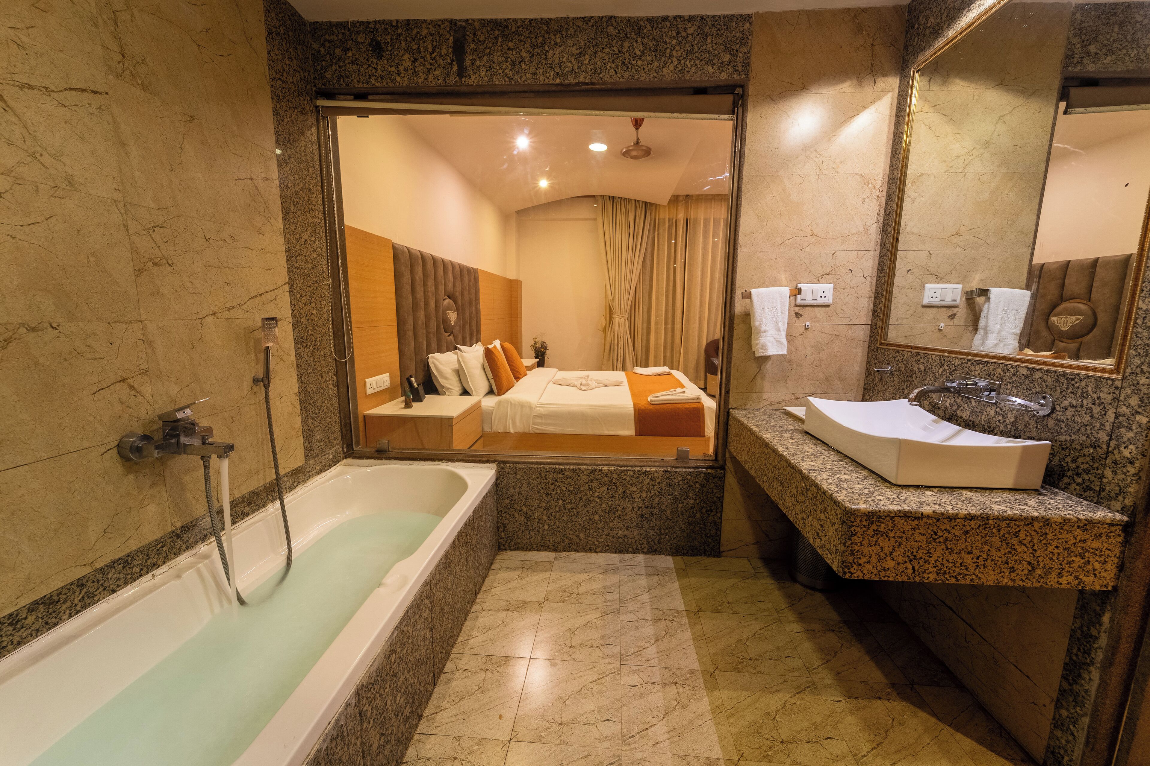A bathroom with a bathtub, sink, and mirror.