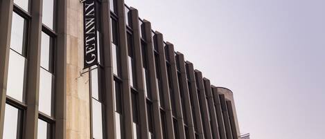 A building with a series of vertical windows and a sign that reads "GETAWAY".