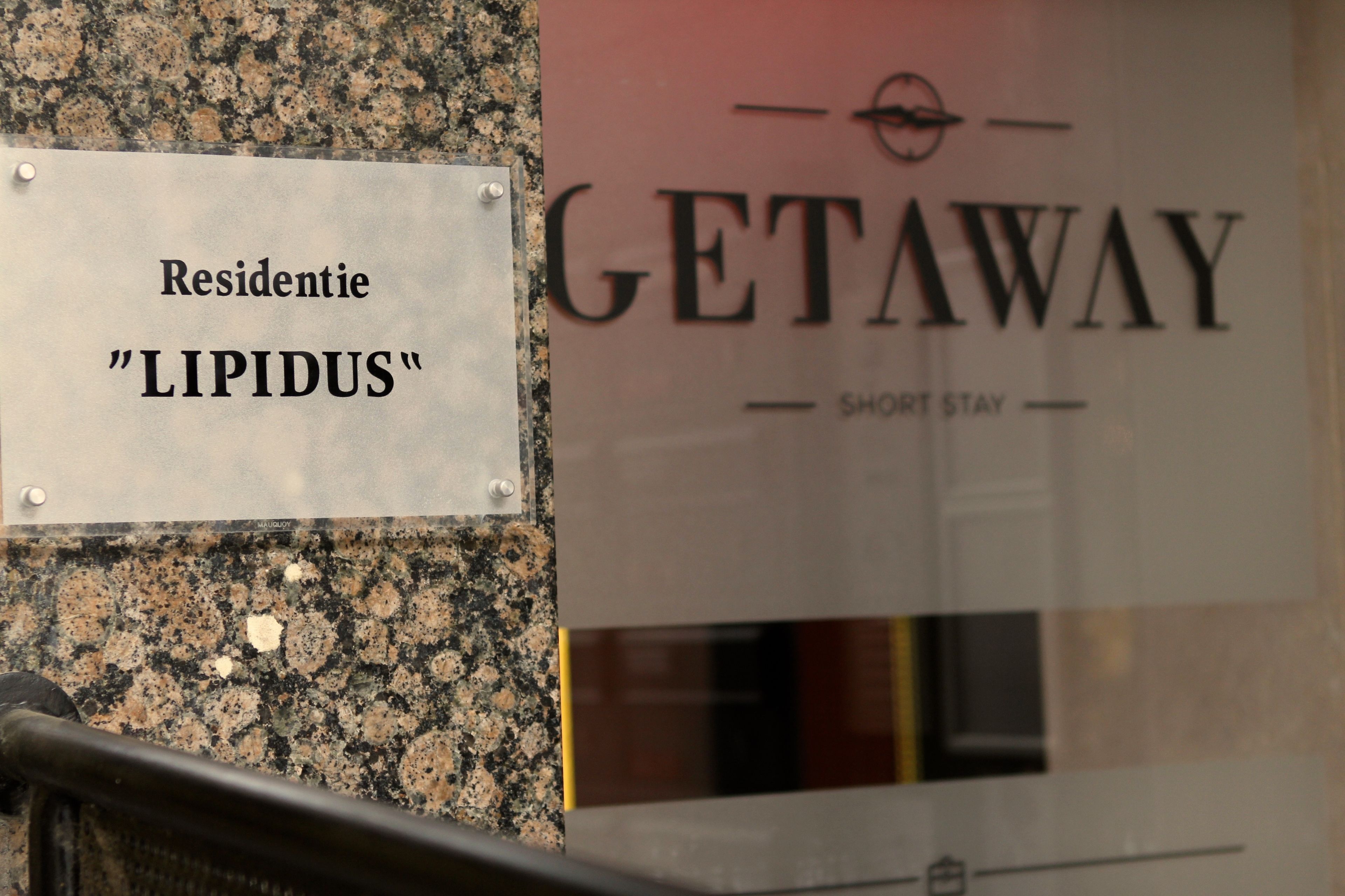 A sign for "GETAWAY" and "LIPIDUS" residence.