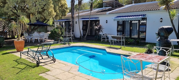 Outdoor pool, pool umbrellas, sun loungers