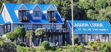 A two-story building with a blue roof and a sign that reads "Lagoon Lodge".