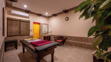 Cozy retreat with a central bed, bench, and small table, complemented by a potted plant and modern amenities.