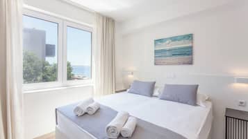 Chambre Quadruple, 2 chambres, balcon, vue mer | Vue sur la plage/lâocĂ©an