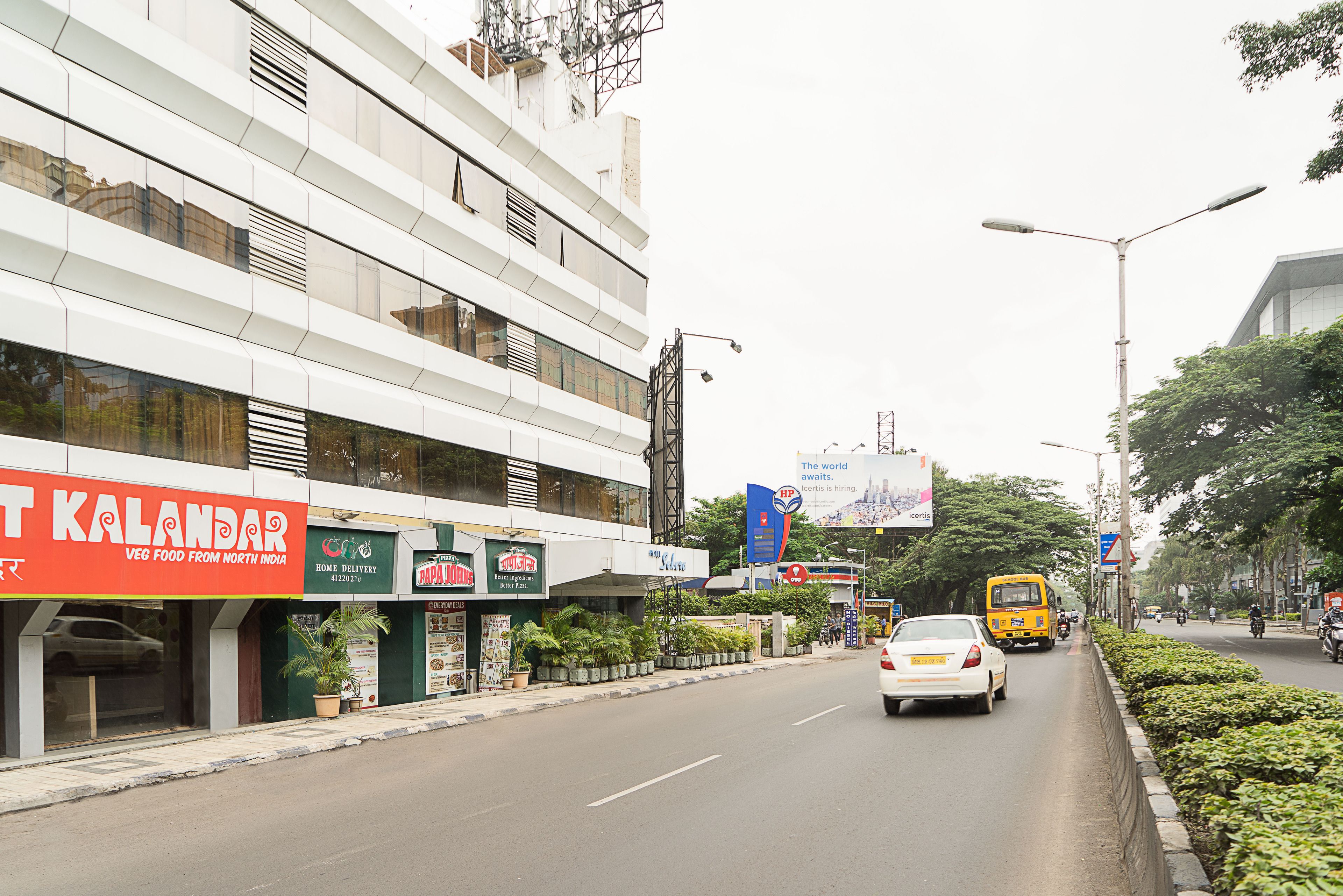 A street view with a building featuring a 'Kalandar' sign, indicating a restaurant.