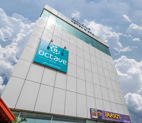 A hotel named 'Octave' with a modern glass facade and a sign for 'FAASO'S' restaurant below. - Octave Hotel & Spa Marathahalli (Bengaluru)