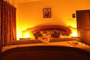 A hotel room with a bed, a headboard, a framed picture on the wall, a 'No Smoking' sign, and a door. - Mount Pleasant Inns & Apartment (Obosomase)