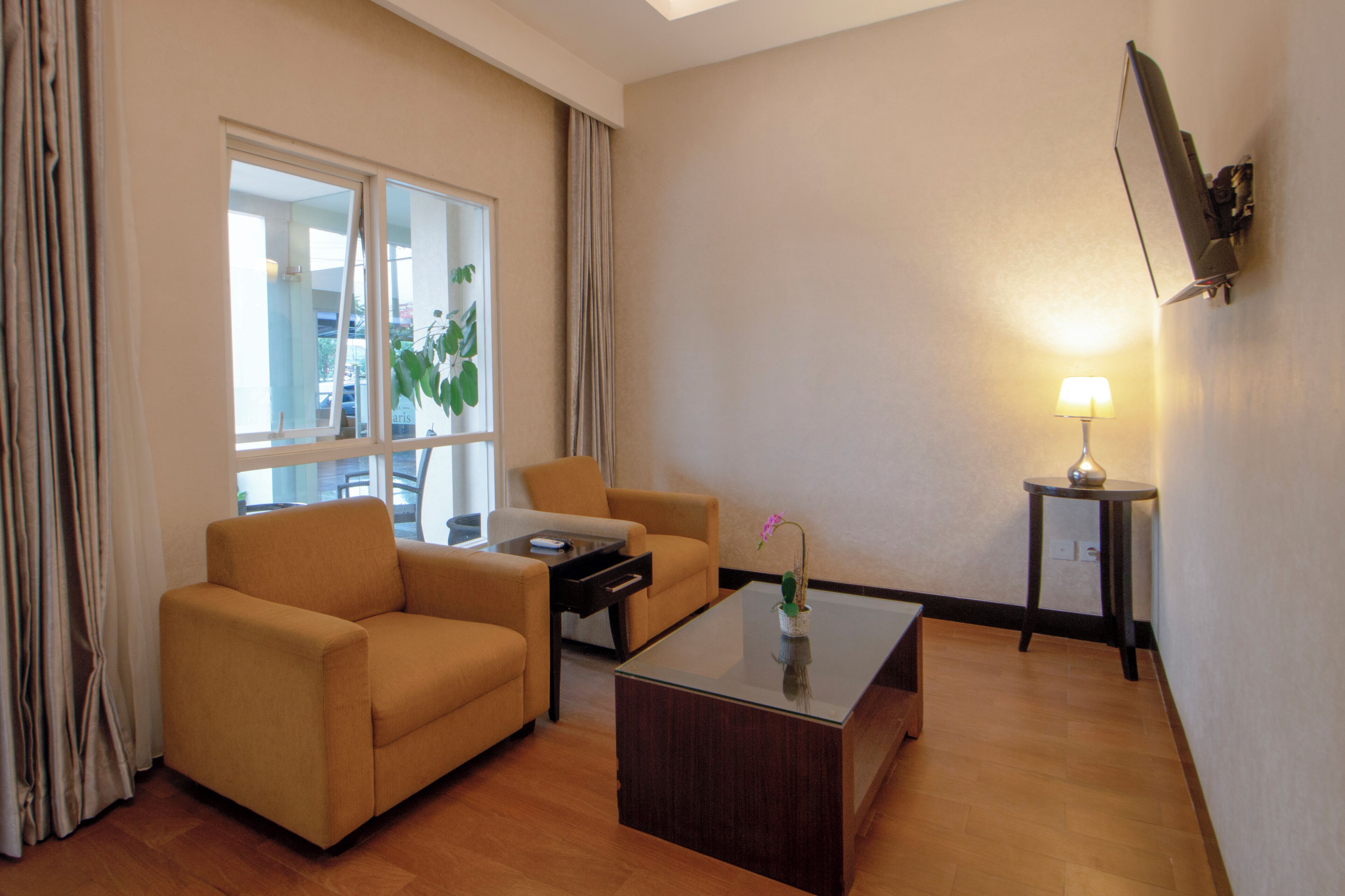 A modern living room with a sofa, coffee table, and a lamp.