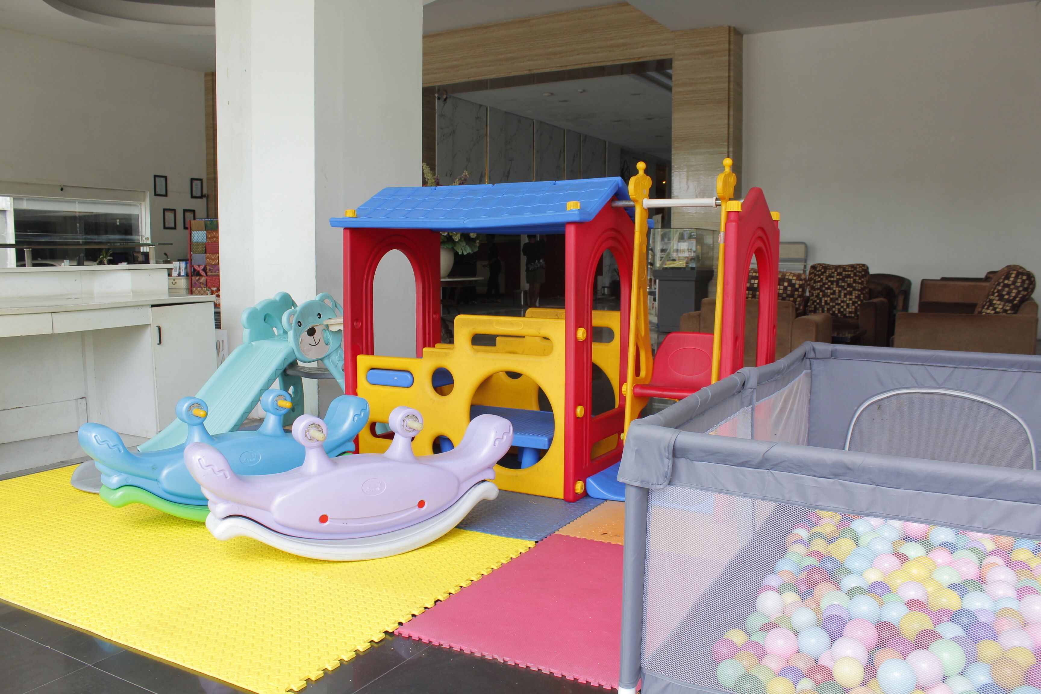 A children's play area with a slide, climbing structure, and a ball pit.