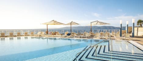 Seasonal outdoor pool, open 9:00 AM to 8:00 PM, pool umbrellas