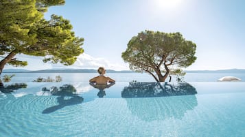 Seasonal outdoor pool, open 9:00 AM to 8:00 PM, pool umbrellas