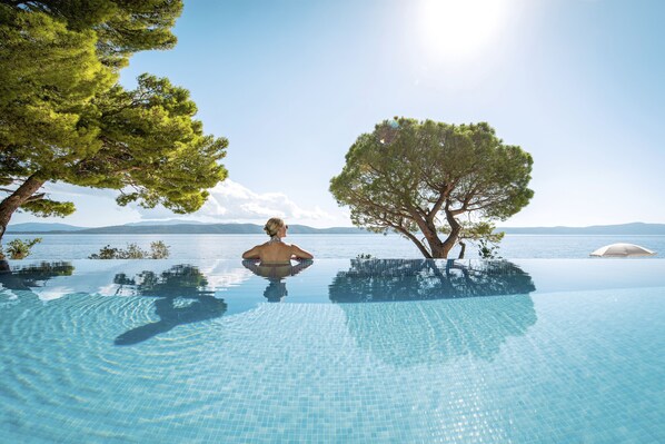 Seasonal outdoor pool, open 9:00 AM to 8:00 PM, pool umbrellas