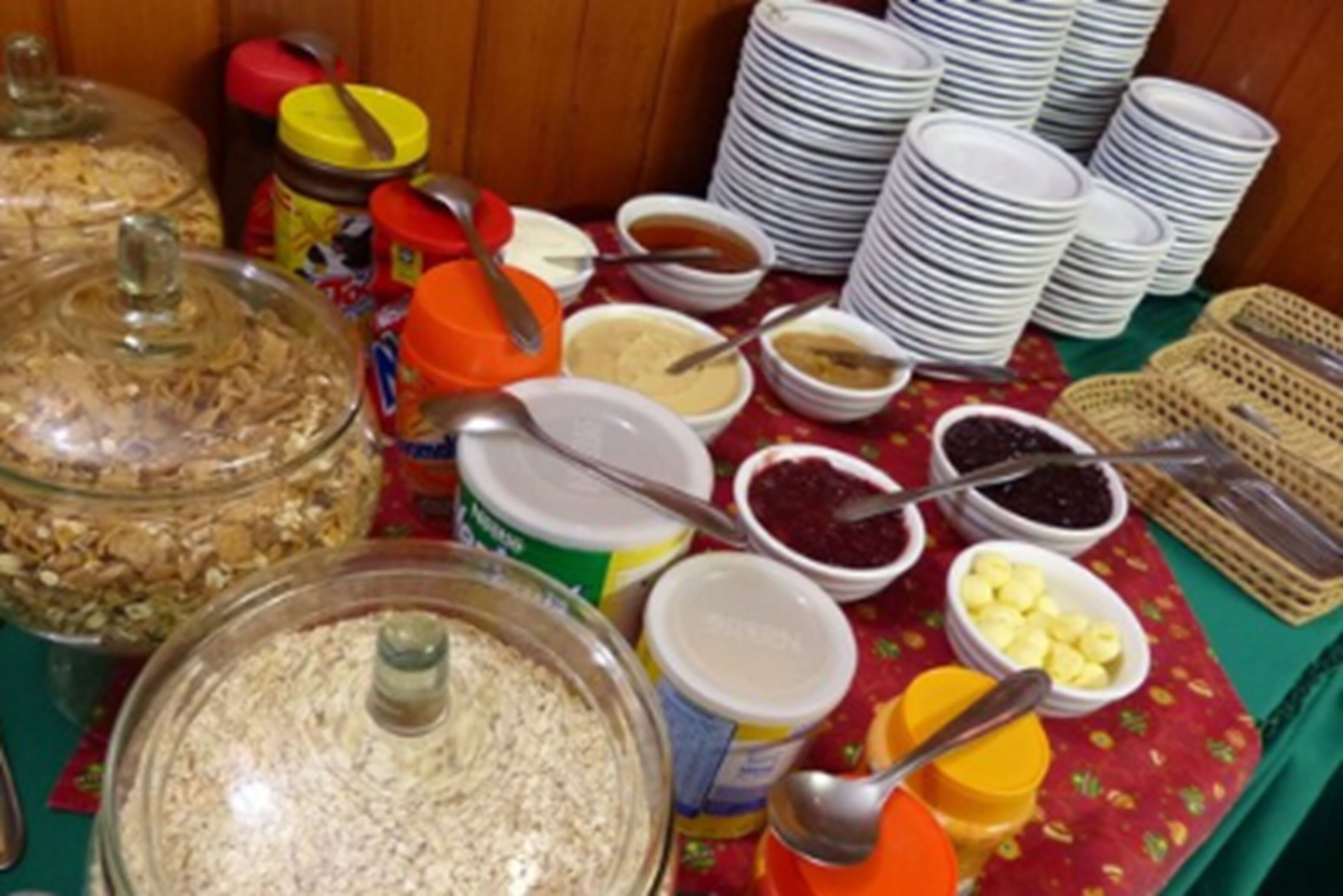 A buffet table with various food items and condiments.
