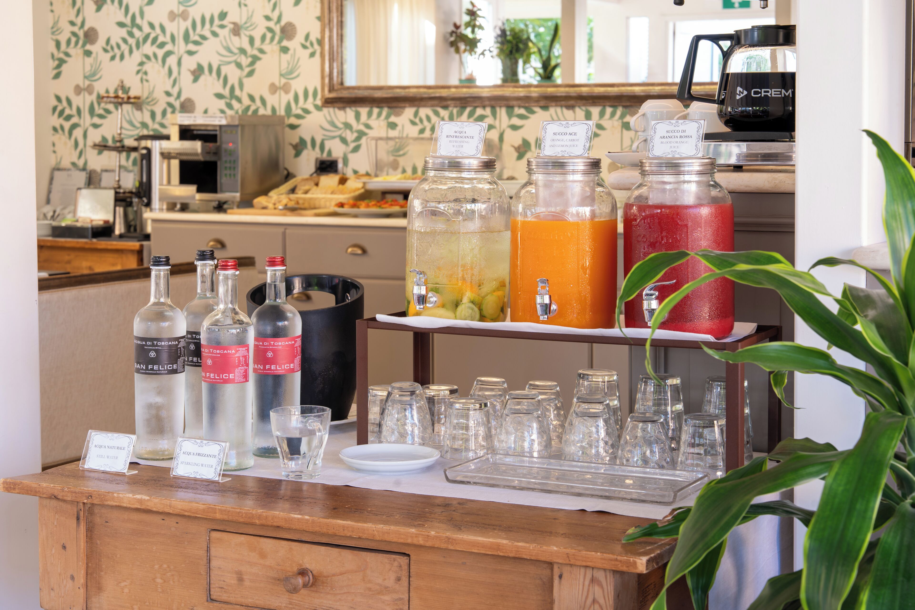 A beverage station with various drink dispensers and glasses.