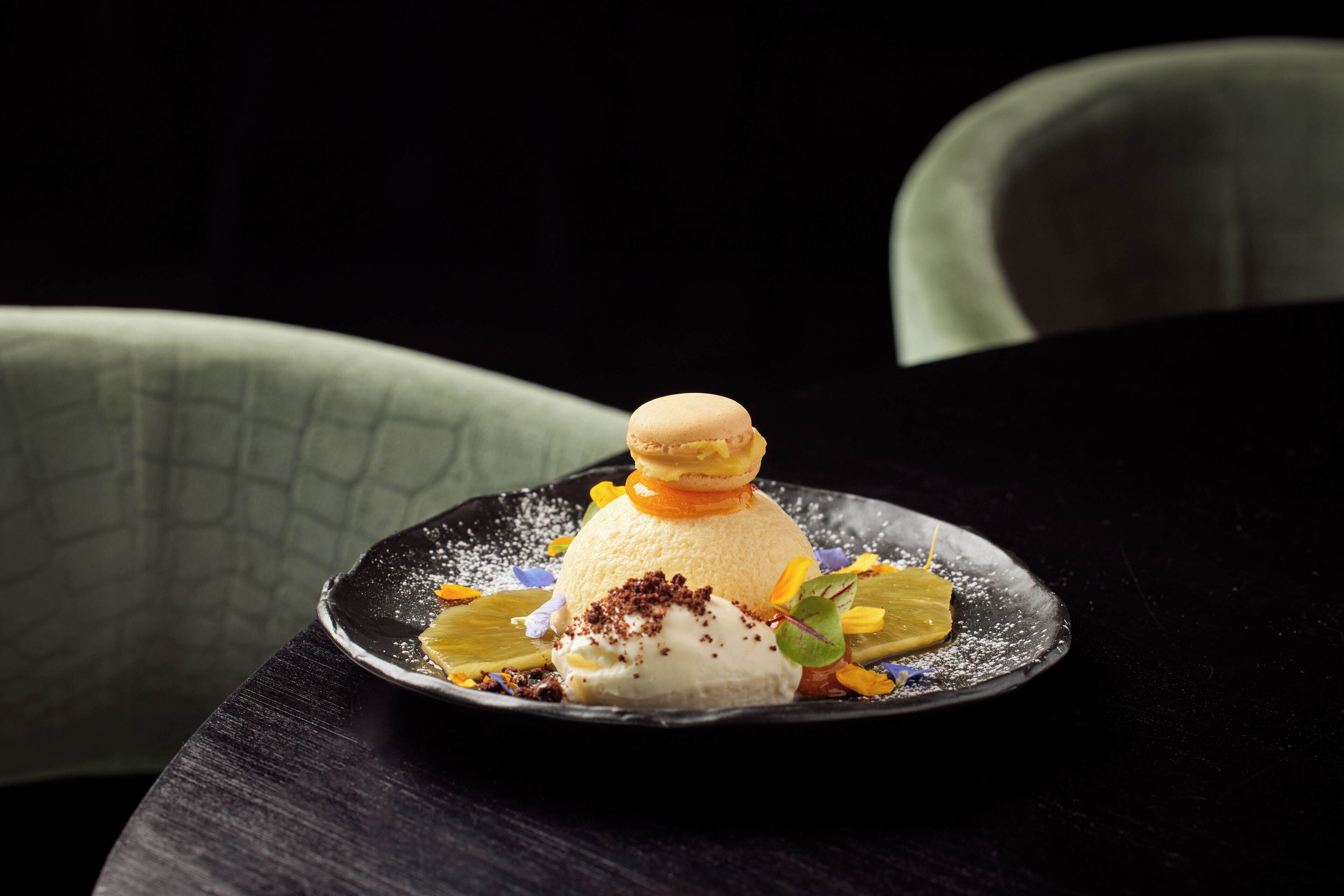 A dessert on a dark plate with a textured background.