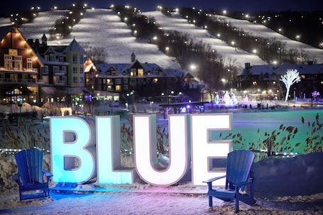 A snow-covered landscape with illuminated buildings and the word "BLUE" in large letters.
