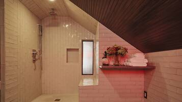 A shower with a wooden ceiling and a pink brick wall.