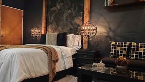 A bedroom with a bed, a nightstand, a dresser, a chandelier, and a bookshelf. - Nativa Posada & Spa (Montemorelos)