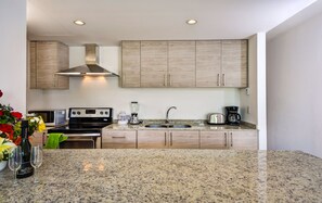 Apartment, 4 Bedrooms | Private kitchen | Full-size fridge, microwave, oven, stovetop