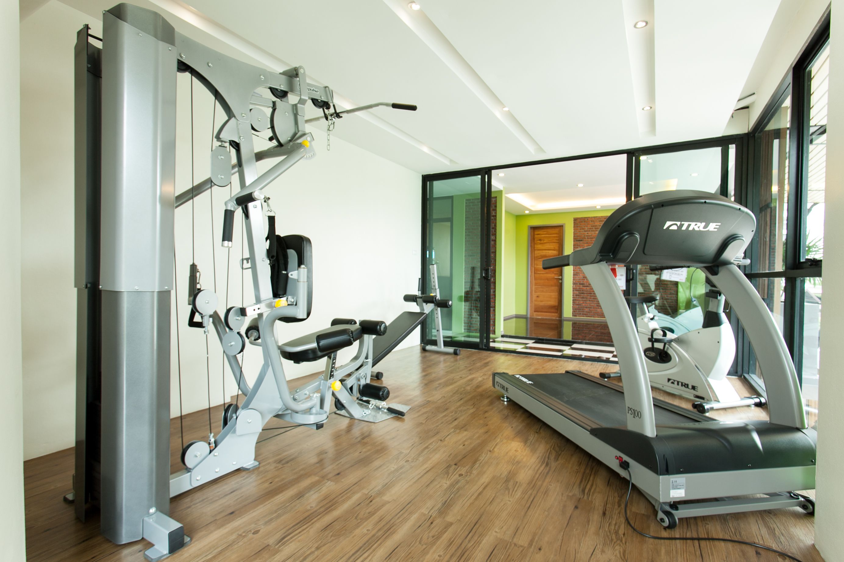 A gym with exercise equipment, including a treadmill and weight machines.