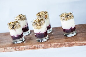 Four glasses of layered dessert on a wooden board. - Nox Hotel (Galway)