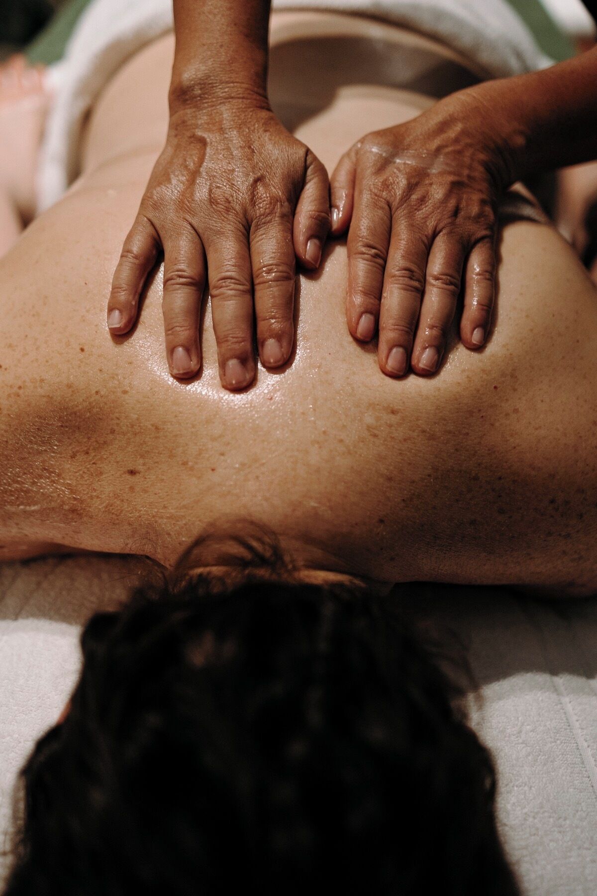 A person receiving a back massage.