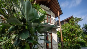 A two-story building with a balcony, surrounded by lush greenery. - Bakung Ubud Resort and Villa (Ubud)