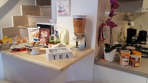A kitchen counter with various food items and a coffee machine.