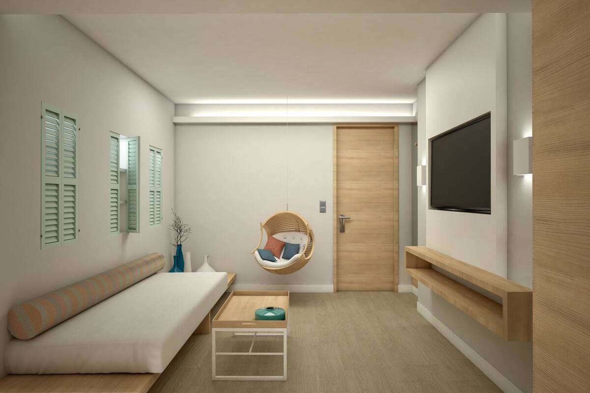 Une chambre moderne et minimaliste, dotée d’un lit, d’un fauteuil suspendu, d’un téléviseur et d’une porte en bois.