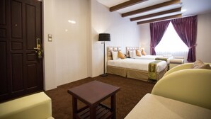 A hotel room with a large bed, a smaller bed, a desk, and a chair. - Rising Venus Hotel (Mandalay)