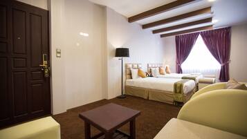 Family Room | Minibar, in-room safe, desk, blackout drapes