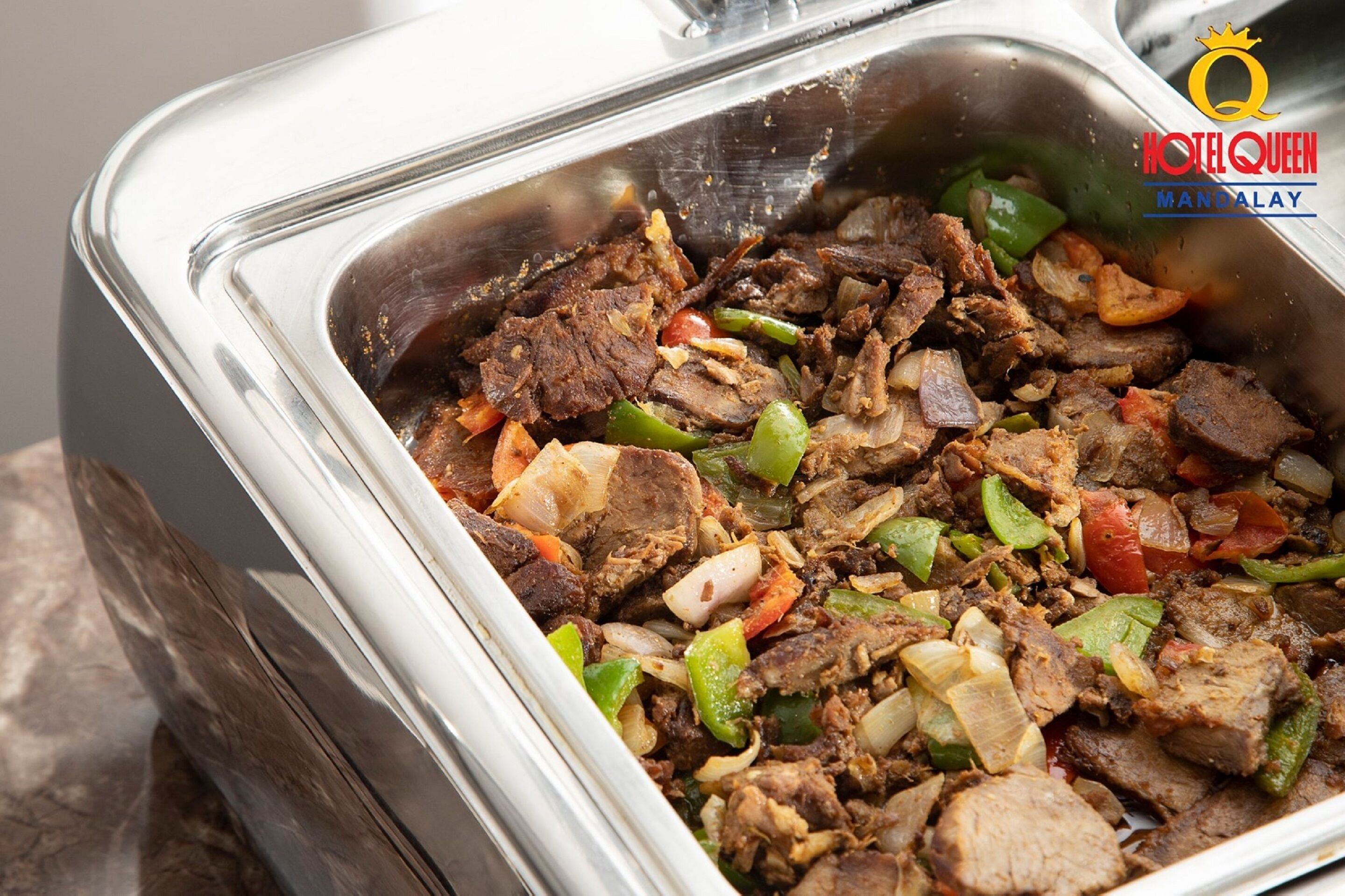 A buffet with a variety of meats and vegetables.