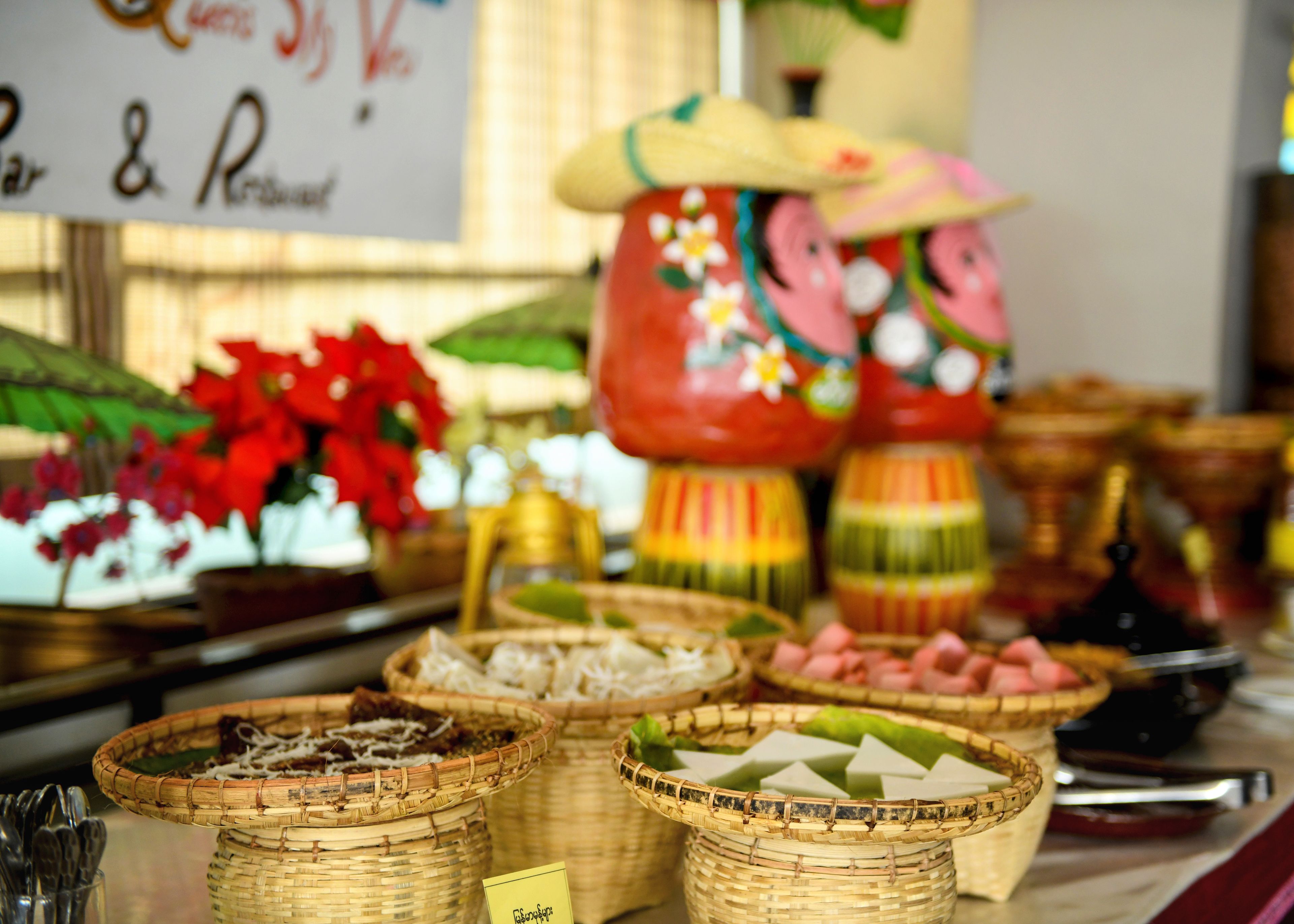 A buffet table with various food items and decorative elements.