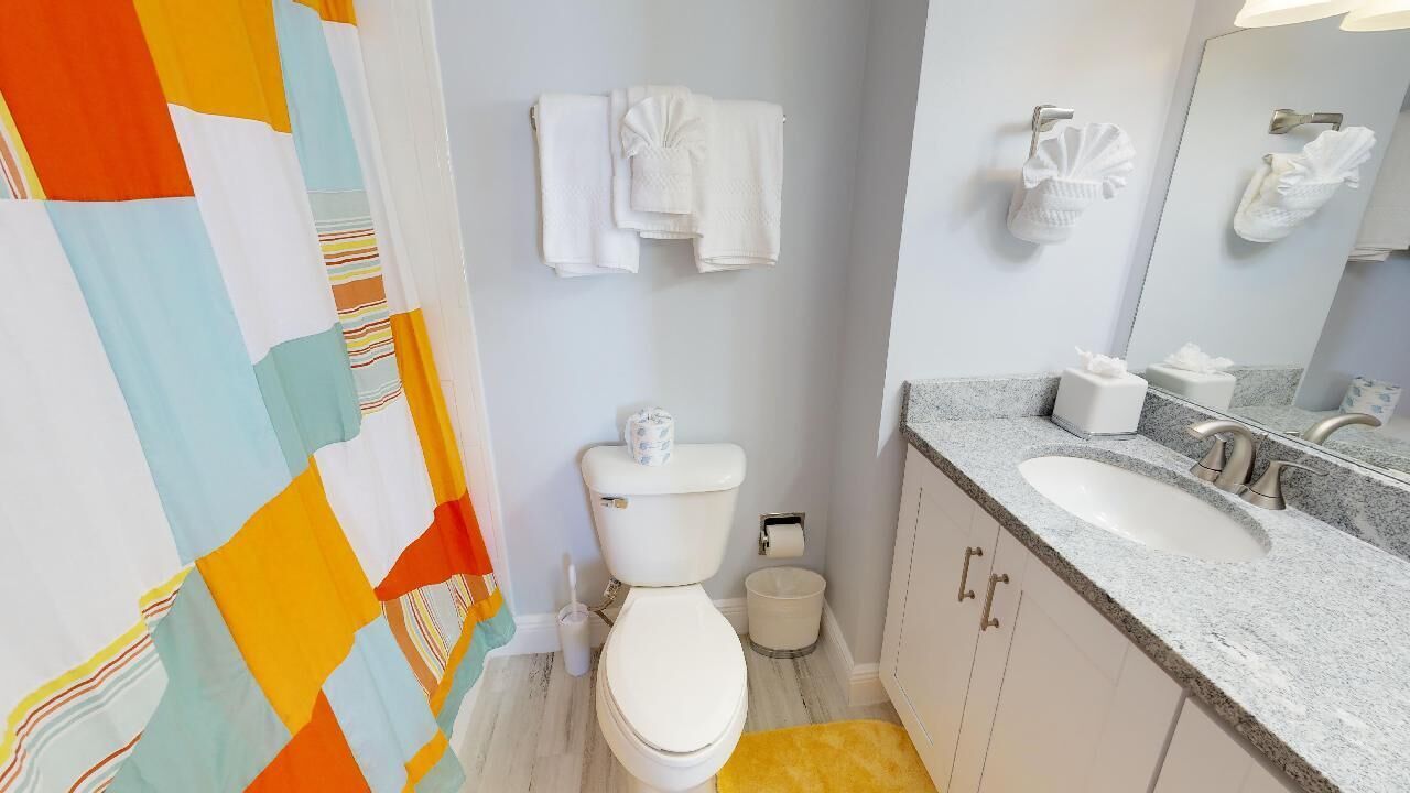 beachfront bliss: 2br ground floor town house | bathroom | combined shower/bathtub, rainfall showerhead, free toiletries