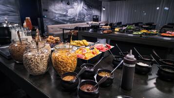 A buffet with various food items and condiments.