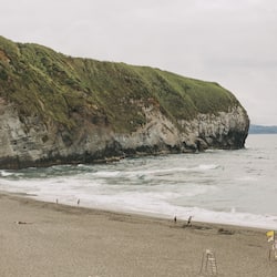 On the beach, black sand, beach towels, beach massages