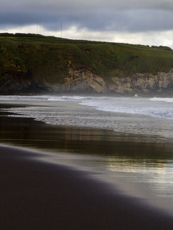 On the beach, black sand, beach towels, beach massages