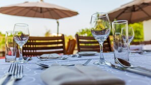 A table set for dining with wine glasses, a water glass, and cutlery. - Eagle's (Accra)