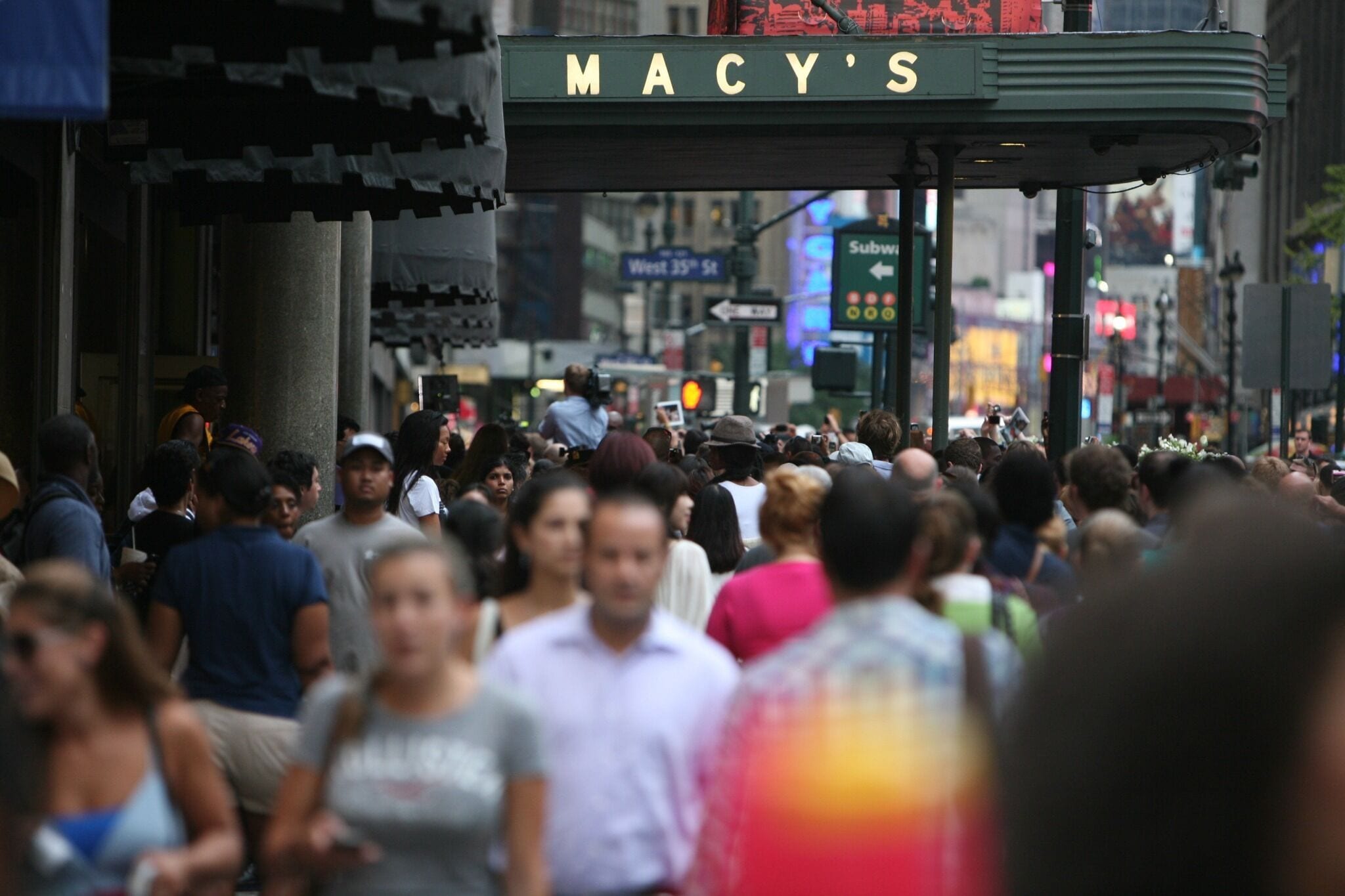 A busy street scene with a Macy's store sign.