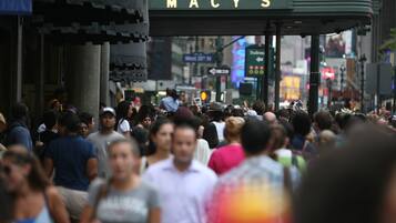 A busy street scene with a Macy's store sign.