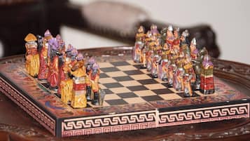 A chessboard with intricately designed pieces and a checkered pattern.