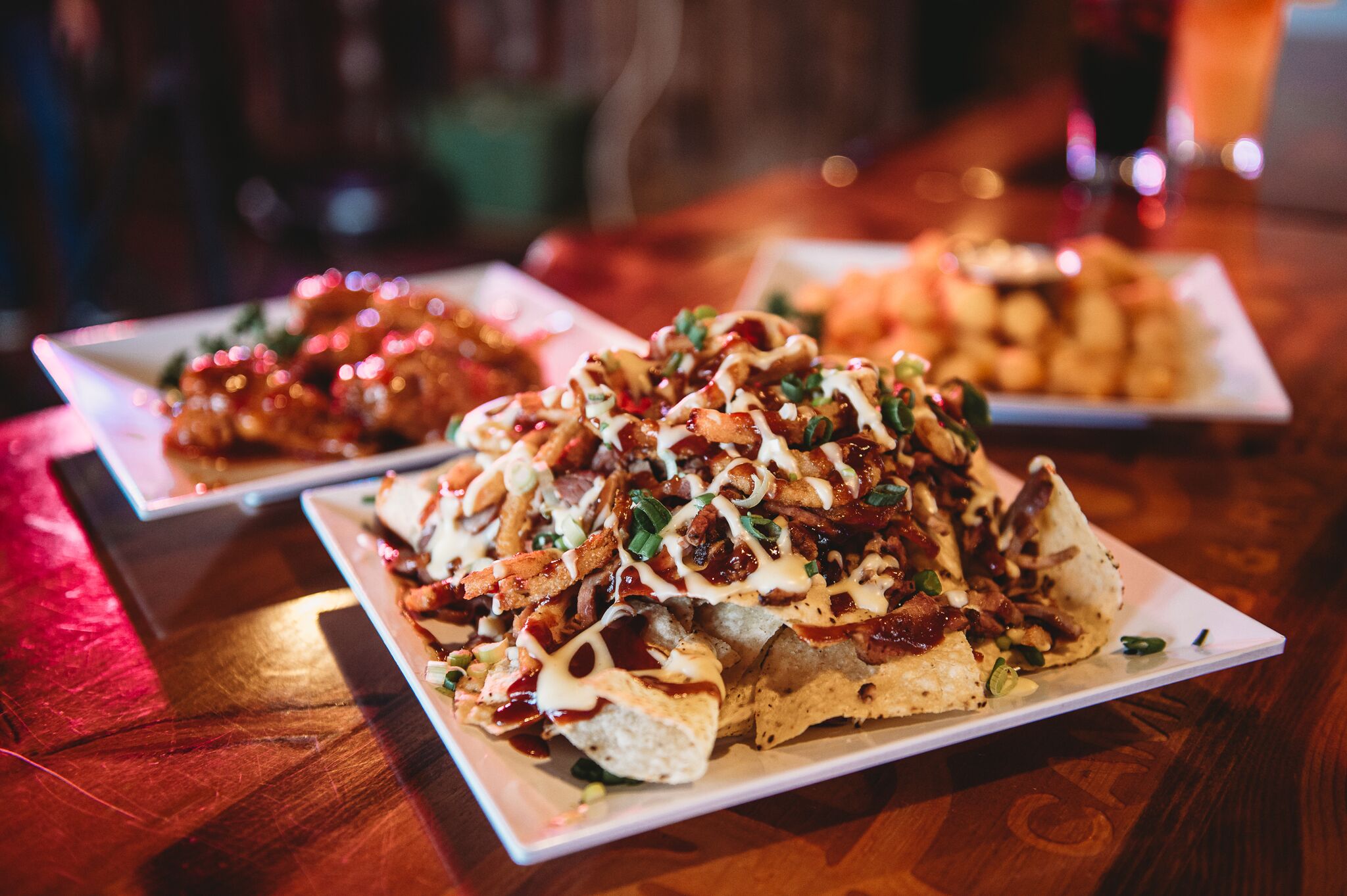 A plate of nachos topped with various ingredients.