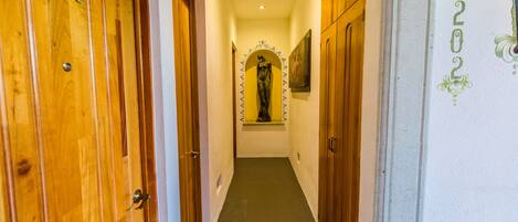 A hallway with wooden doors numbered 201 and 202, leading to rooms.