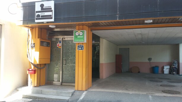 A building entrance with a sign for 'rumble' and a 'tripadvisor' sign. - OxbloodK (Gwangju)