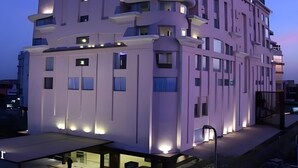 A multi-story hotel with a modern design, featuring balconies and a flat roof. - Renest Jaipur (Jaipur)