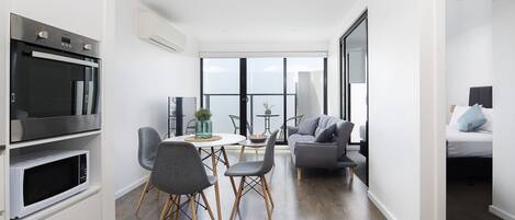 One Bedroom Apartment with Balcony | Living area | 50-inch Smart TV with satellite channels, TV